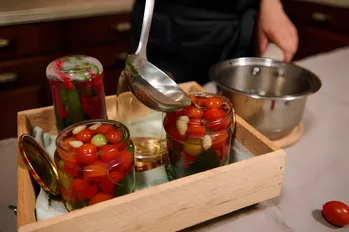 Jeg putter agurker, peberfrugter og tomater i glas og hælder varm marinade i dem og opbevarer glassene i skabet ved stuetemperatur.